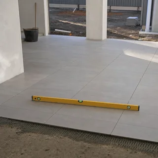 Commercial floor tiling being laid in a retail fitout space