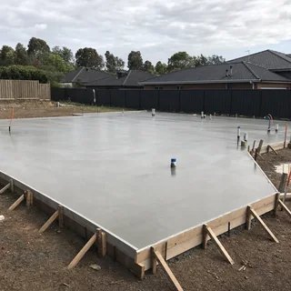 Freshly poured and screeded concrete house slab with formwork