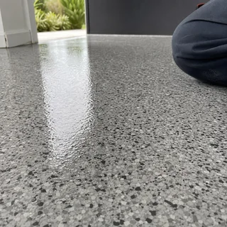 Close view of a grey and black vinyl flake epoxy floor coating