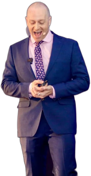 Levi Saunders on stage in a blue suit, laughing as he speaks