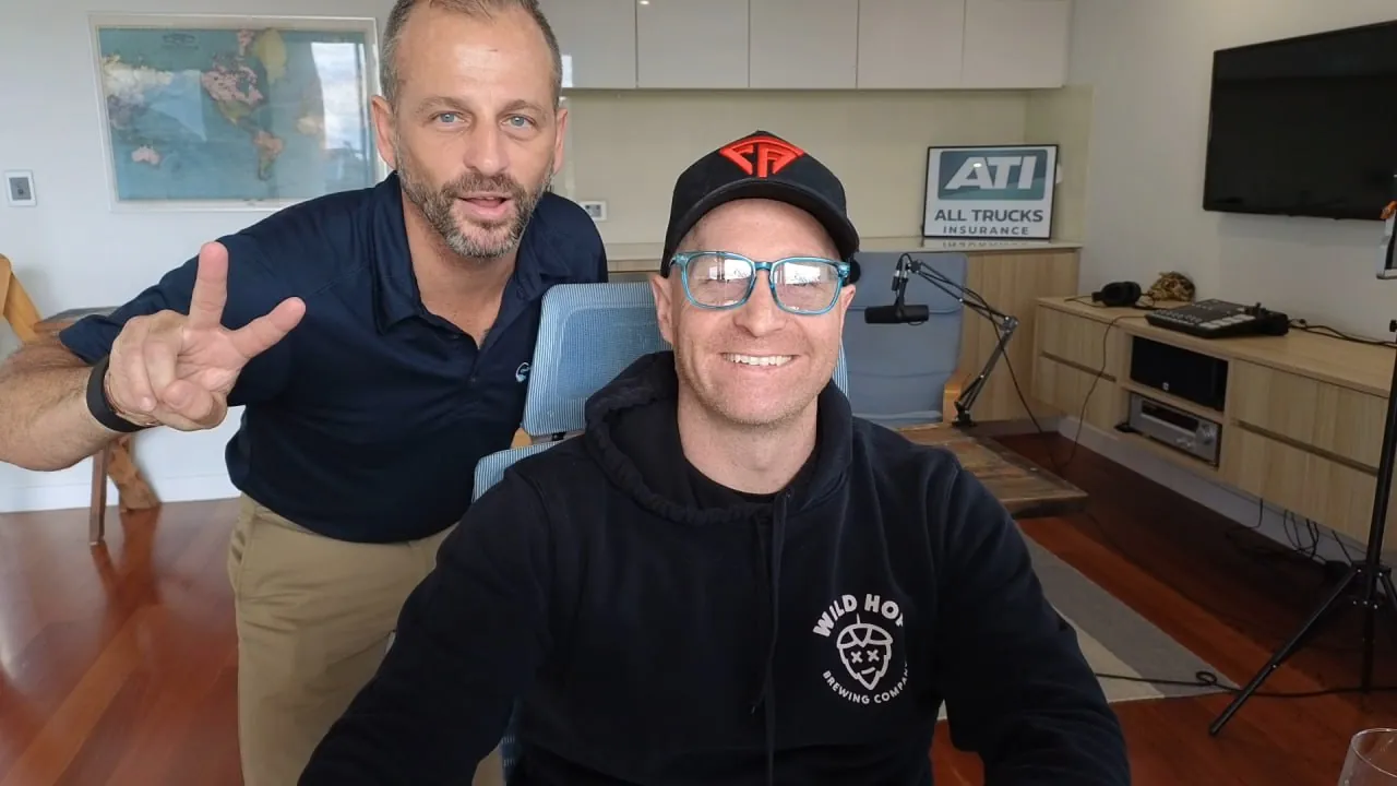 Levi Saunders of The Lead Gen Lab with Paul from All Trucks Insurance, the ATI sign on the shelf behind them.