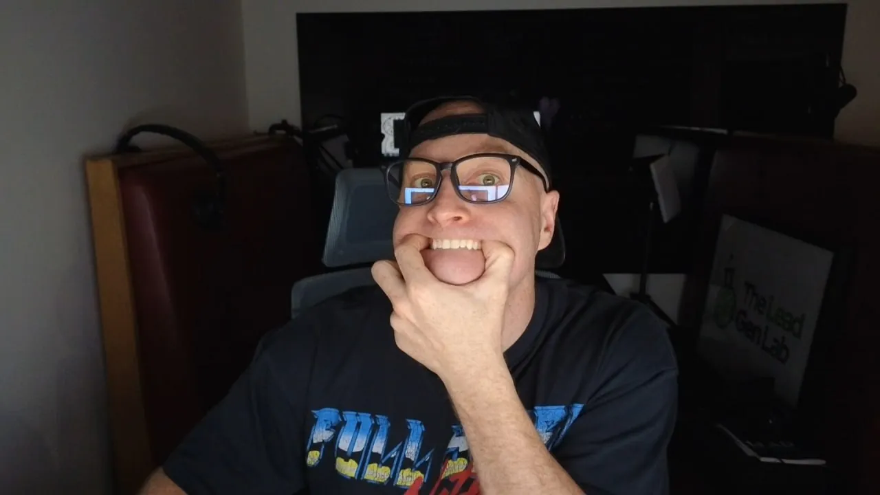 Levi Saunders at his desk pulling a shocked face, hand over his mouth