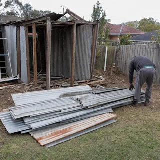 Old metal garden shed and carport part way through being dismantled